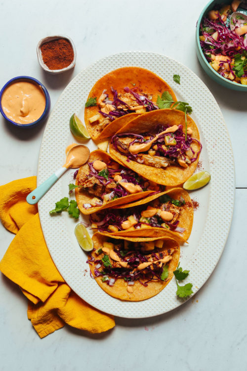 Large platter filled with dairy-free Grilled Fish Tacos topped with Pineapple Cabbage Slaw
