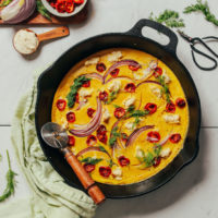 Mini pizza cutter resting in a pan of our Vegan Frittata recipe