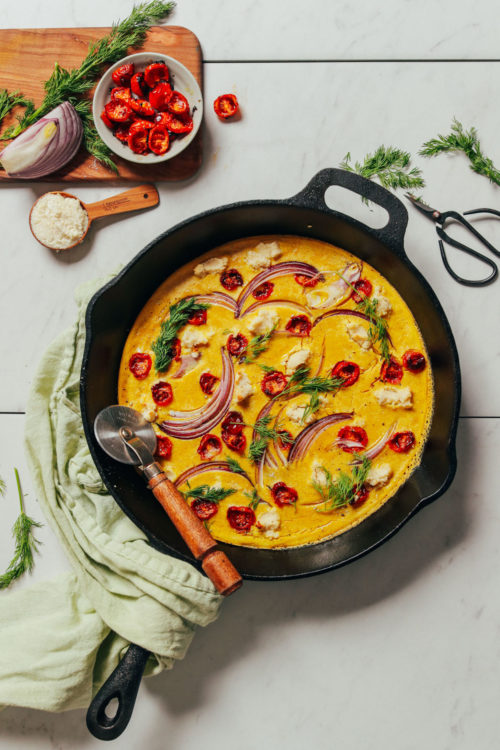 Mini pizza cutter resting in a pan of our Vegan Frittata recipe