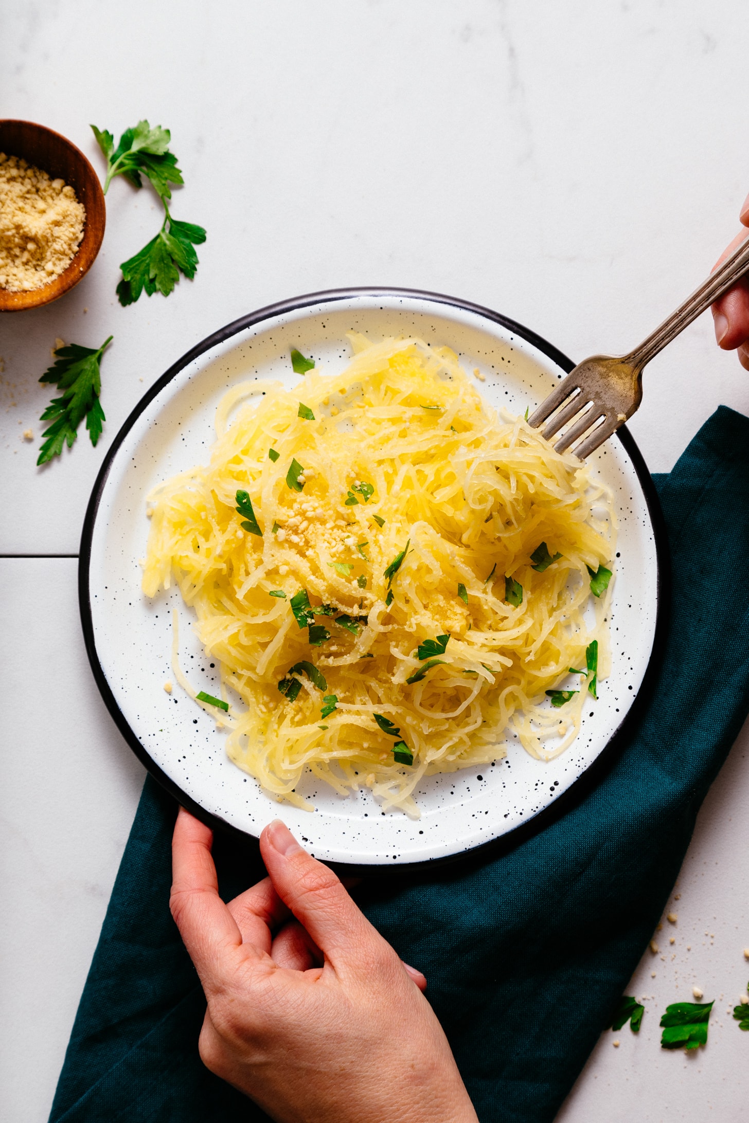 Swirling spaghetti squash strands on a fork