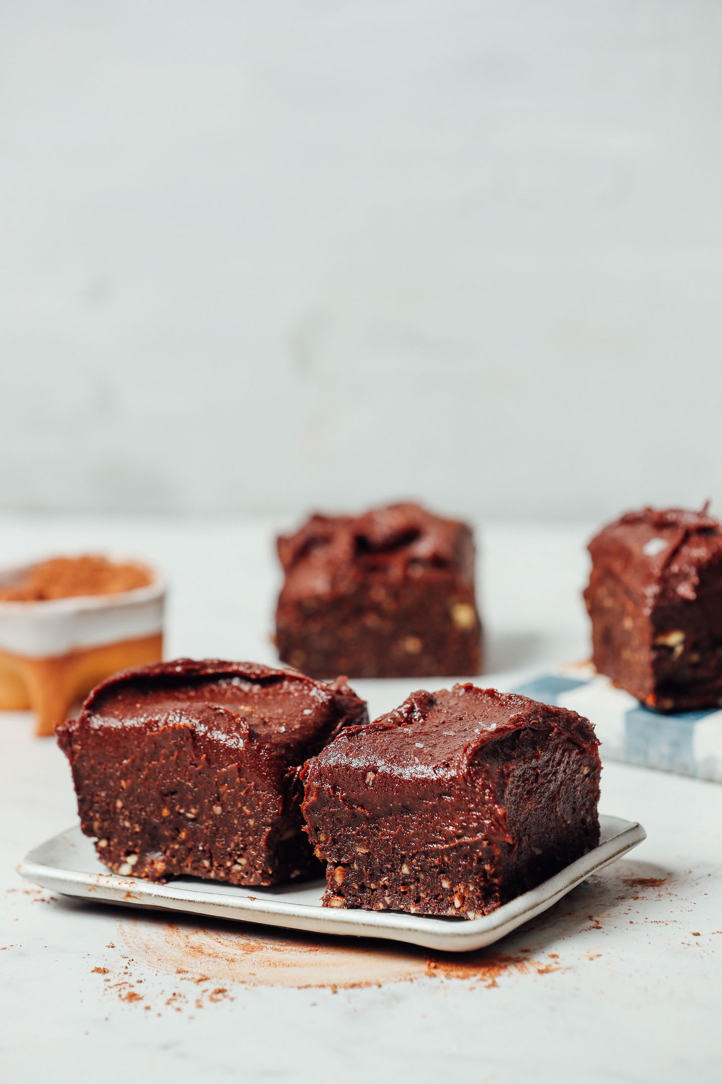 Tray with two gluten-free brownies frosted with Vegan Chocolate Frosting