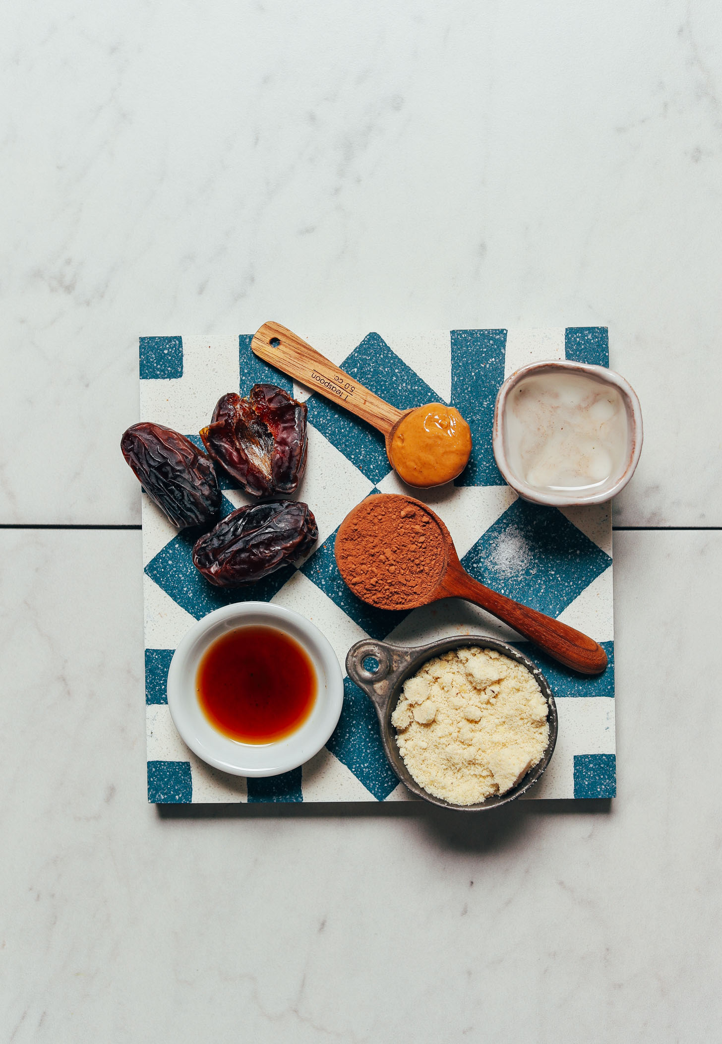 Blue and white tile filled with ingredients for making our 10-Minute Vegan Chocolate Truffles recipe