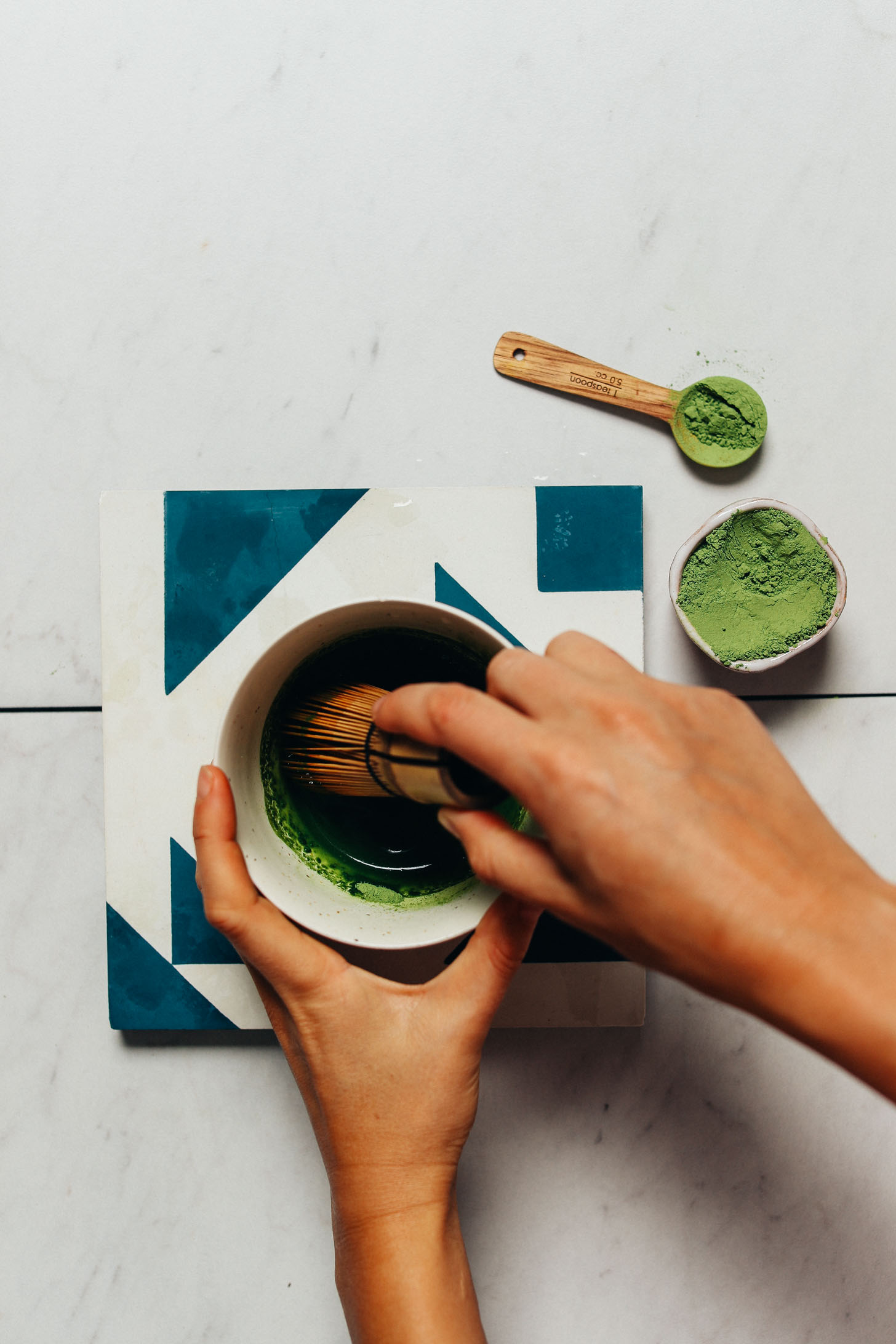 Using a bamboo whisk to stir matcha and water