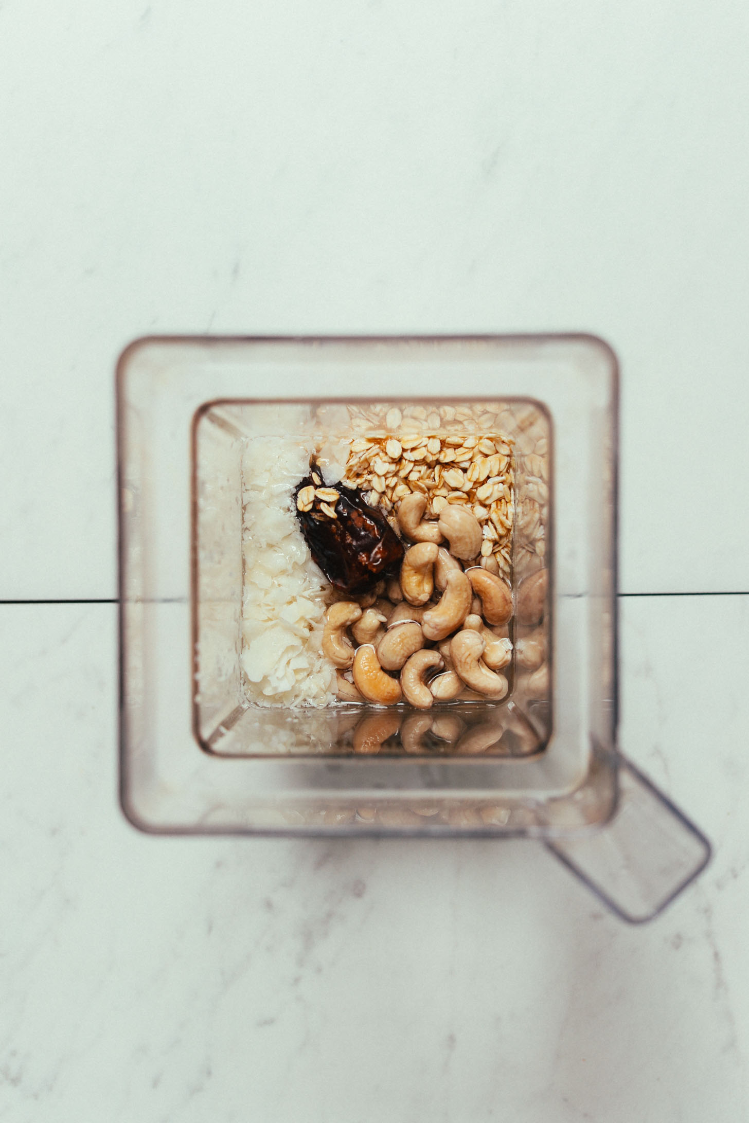 Blender filled with ingredients for making our Cashew Coconut Oat Milk Creamer