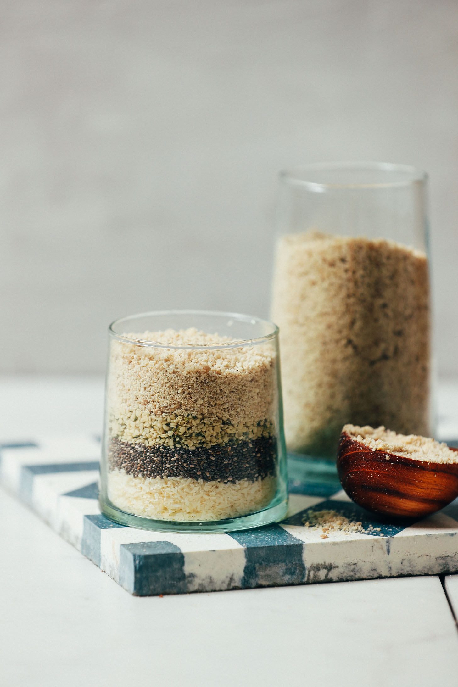 Jars and spoon full of our DIY Seed Cycling Mix for the luteal phase