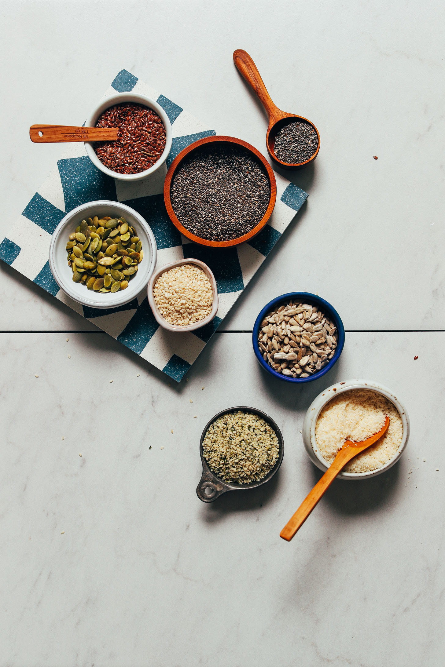 Bowls of seeds for making homemade Seed Cycling Mixes for adding to yogurt, smoothies, and more