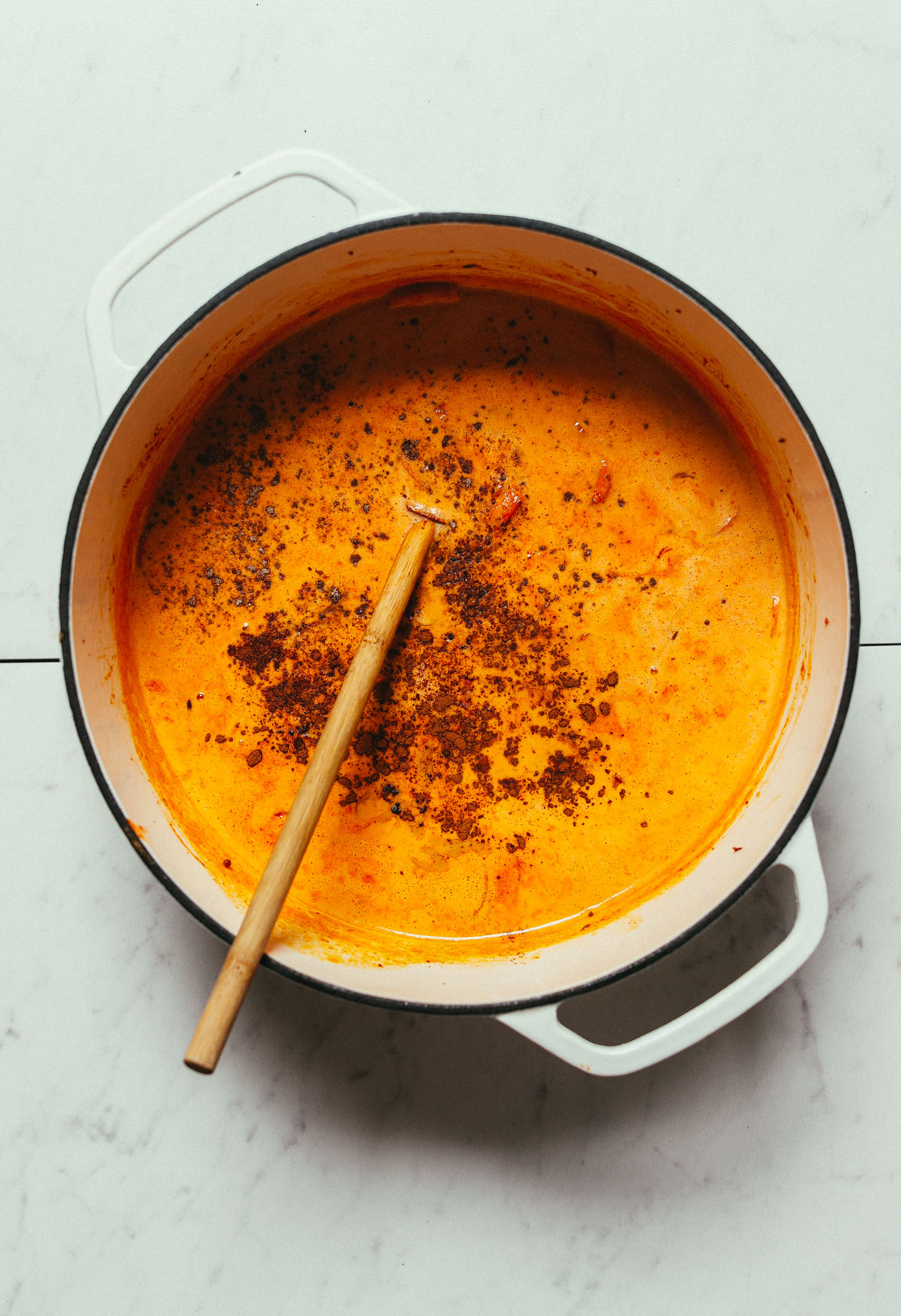 Using a wooden spoon to stir our gluten-free Massaman Curry recipe