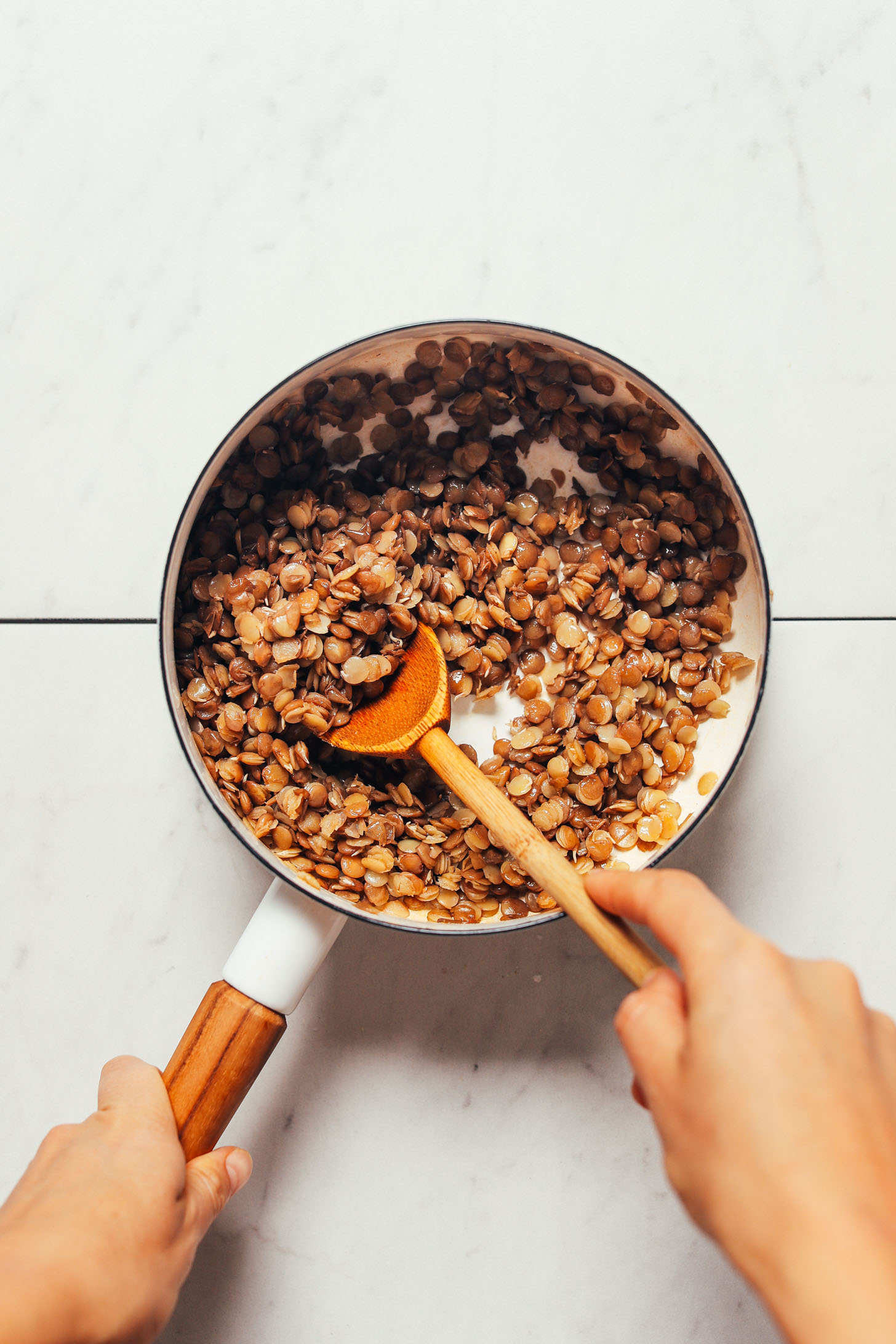 Cooking lentils in a saucepan for our Mujadara recipe