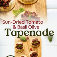 Cutting boards of crackers topped with hummus and homemade Basil Olive Tapenade