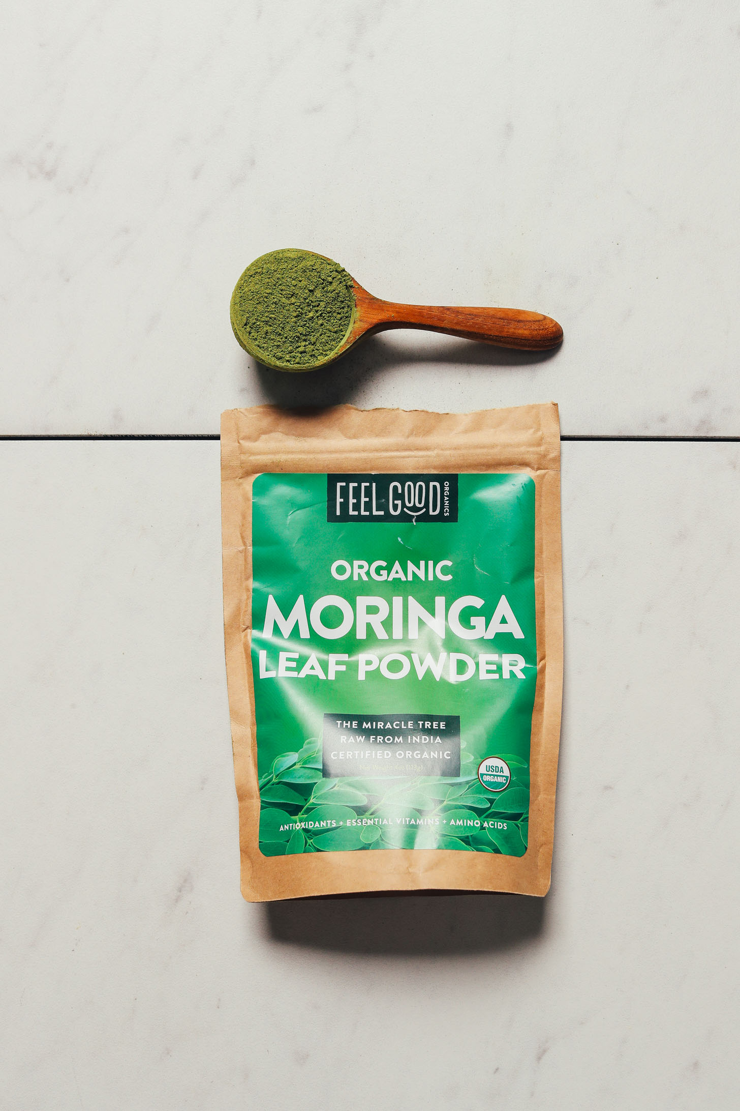 Bag and spoonful of Feel Good Moringa Powder for our review of the best moringa brands