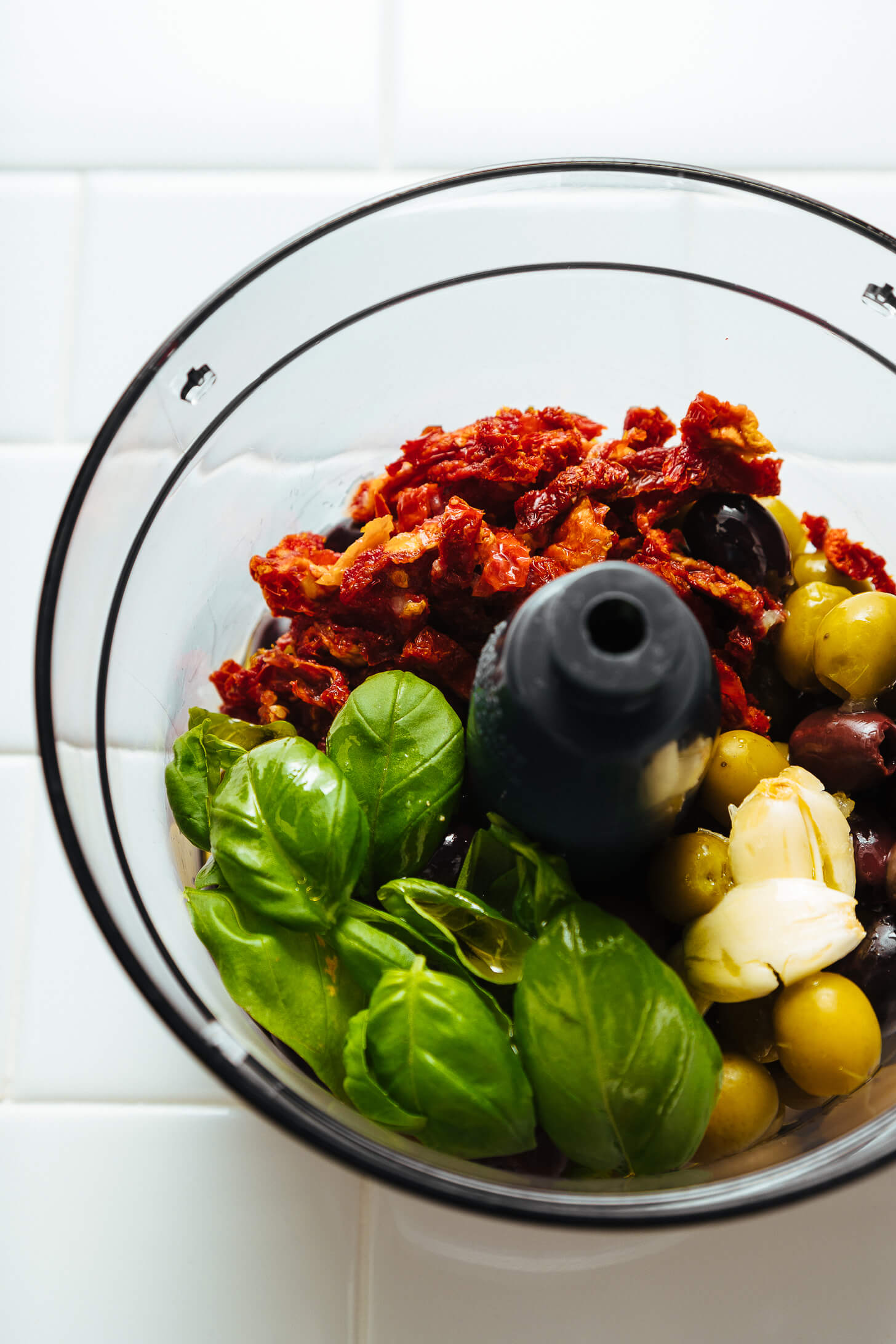 Food processor with ingredients for making our simple Olive Tapenade recipe