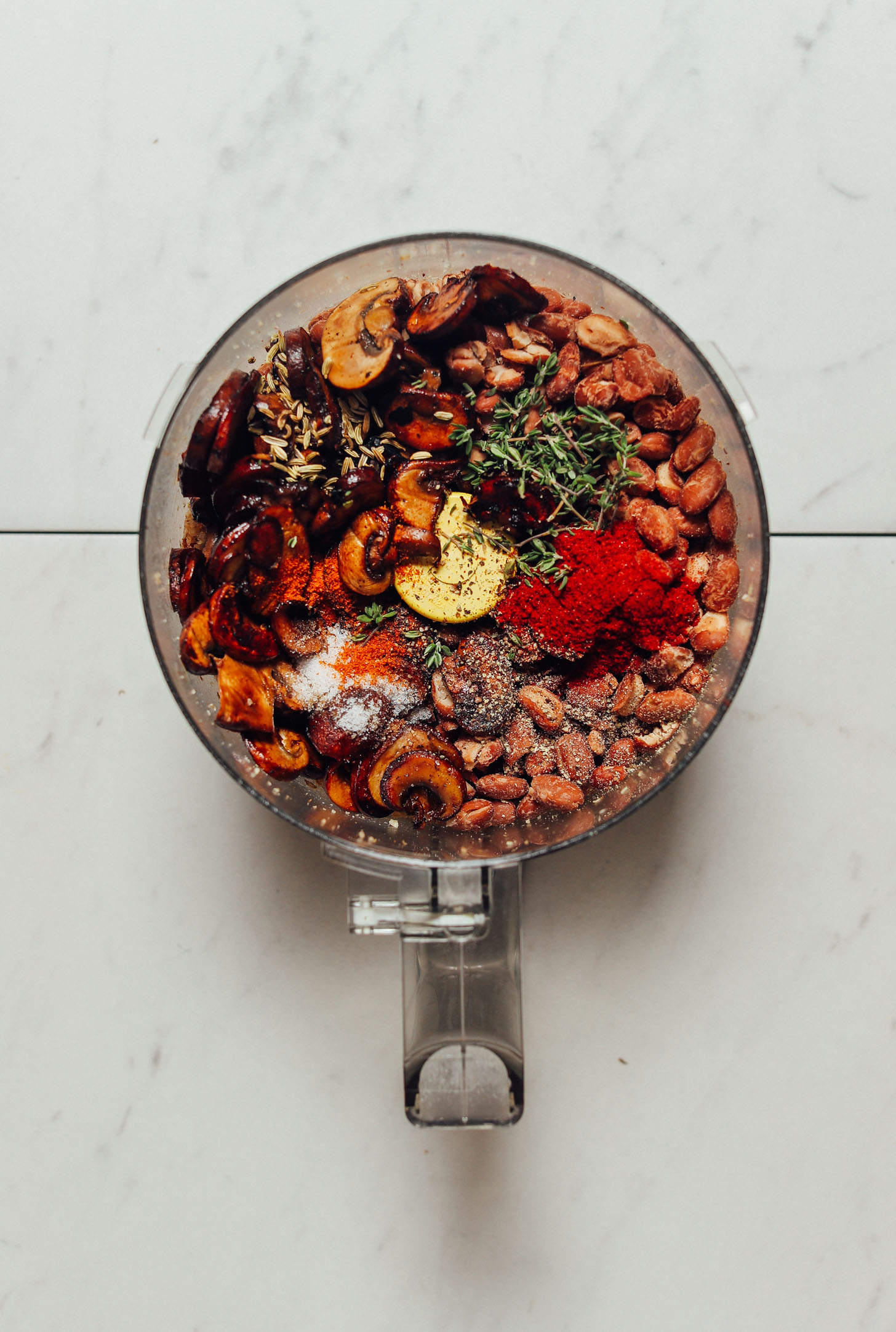 Food processor filled with ingredients for making our healthier real food-based Vegan Sausages