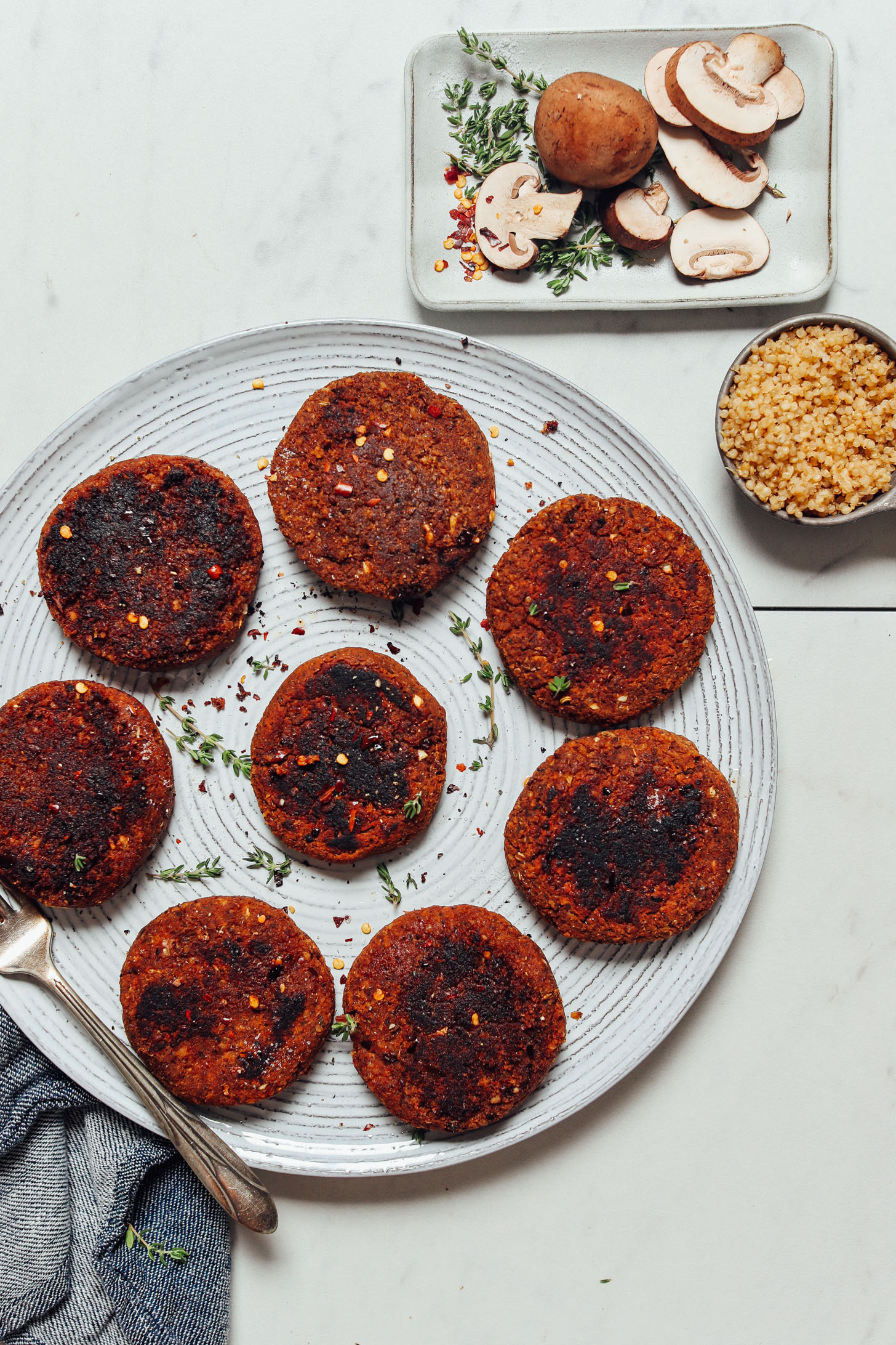 Plate of patties made with our Vegan Sausage recipe beside ingredients used to make it