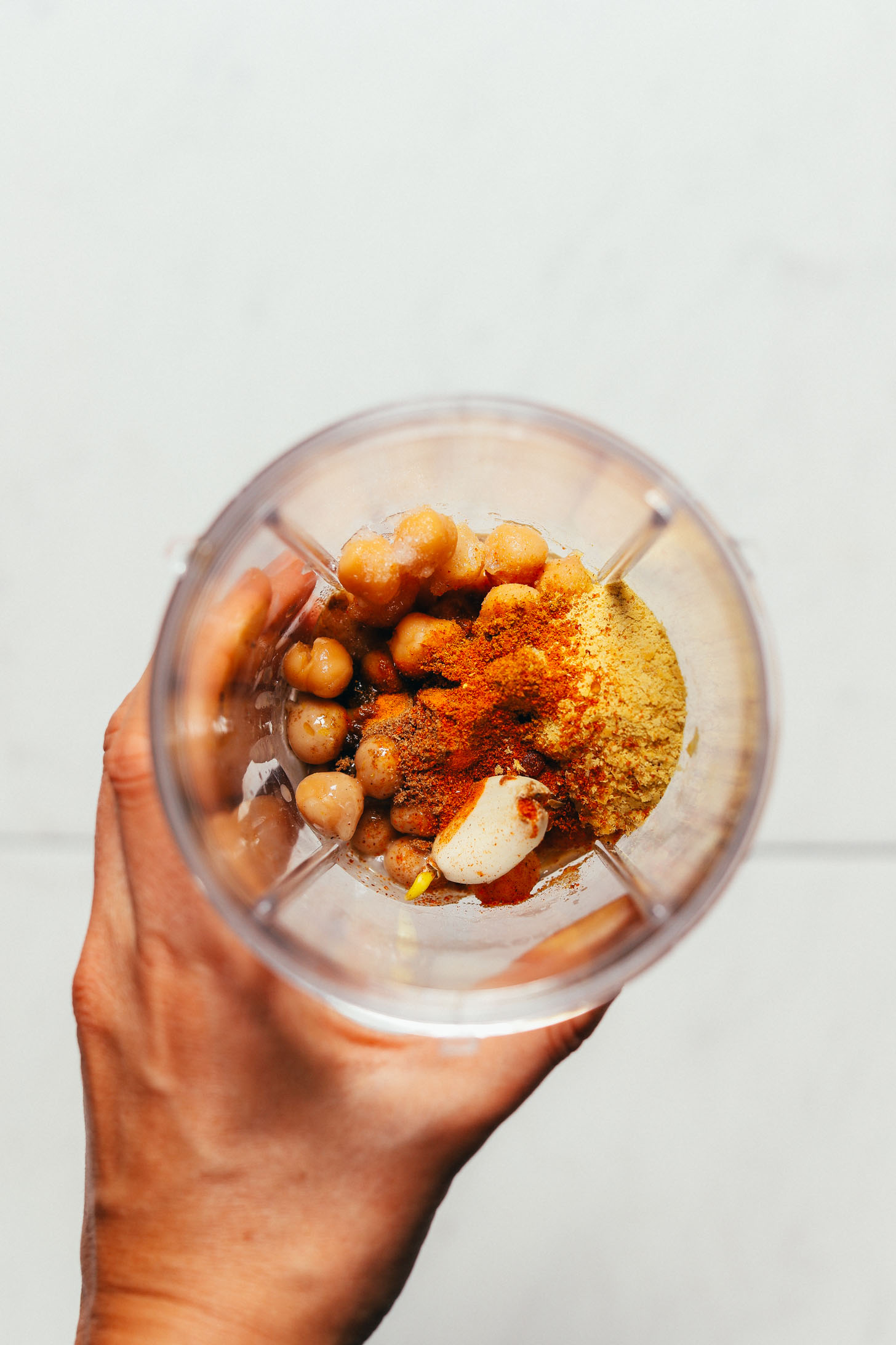Food processor filled with ingredients for making our Turmeric Chickpea Sauce
