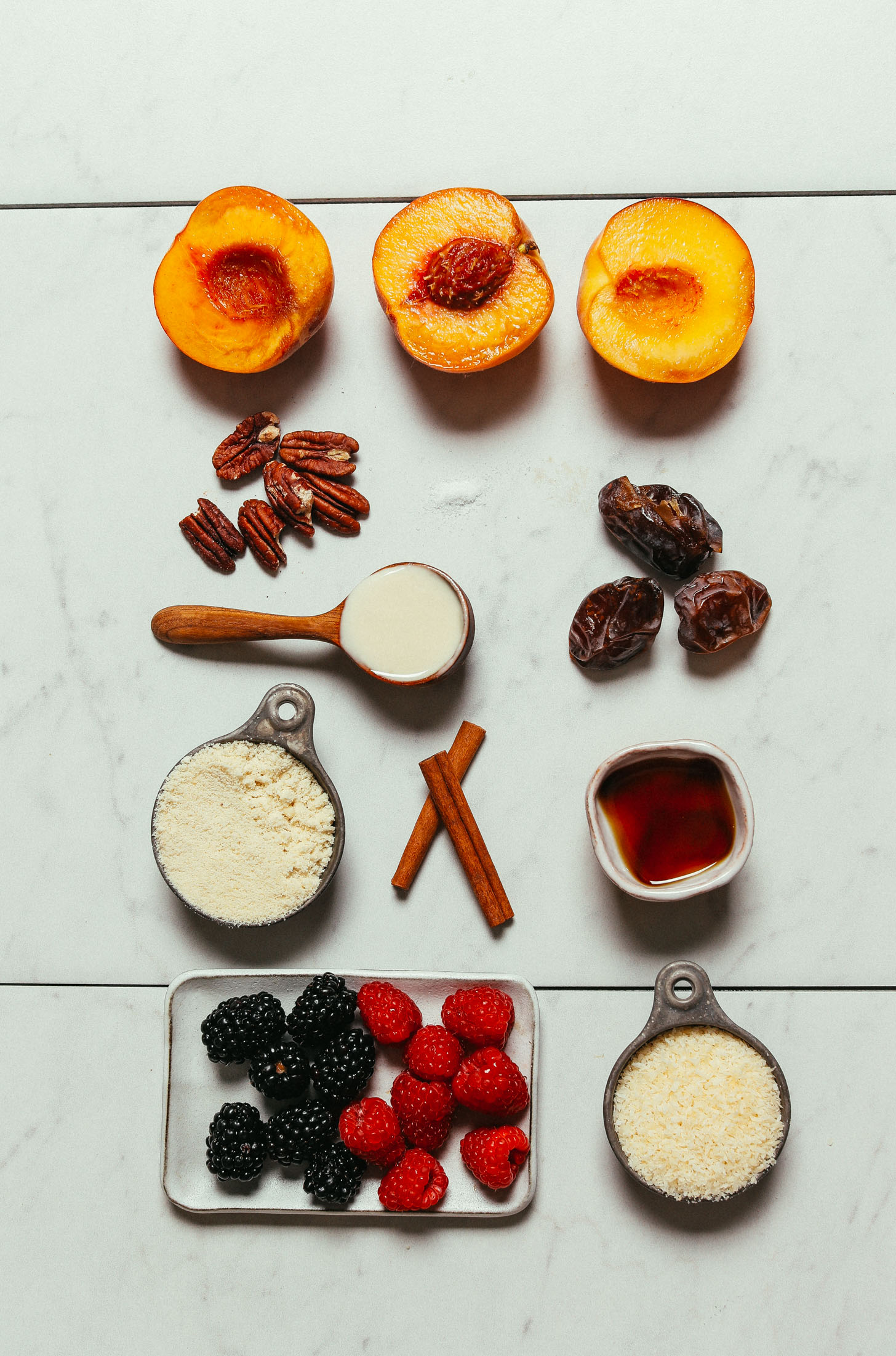 Peaches, berries, dates, pecans, coconut. and other ingredients to make our Gluten-Free Fruit Crisp recipe