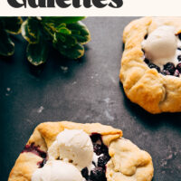 Mini vegan blueberry galettes with scoops of vanilla ice cream