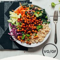 Crispy Miso Chickpea Bowl beside fresh limes and other ingredients used to make it