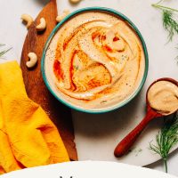 Spoonful and bowl of Vegan Chipotle Ranch Dressing beside ingredients used to make it