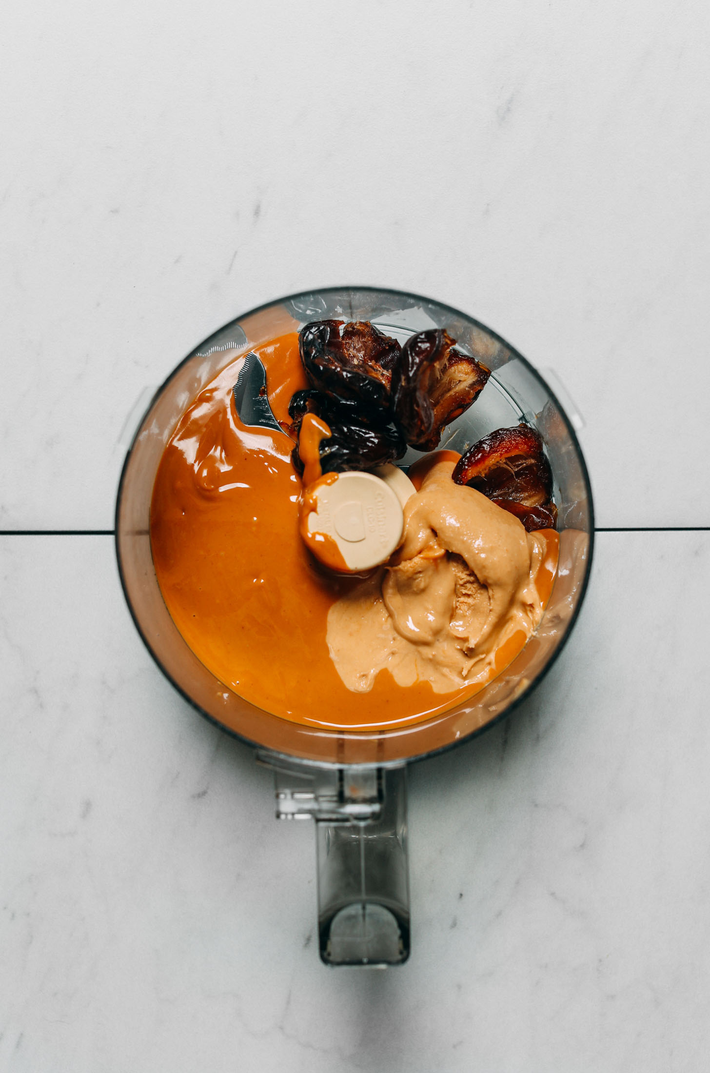 Food processor filled with wet ingredients for making our 5-Ingredient Protein Bars recipe