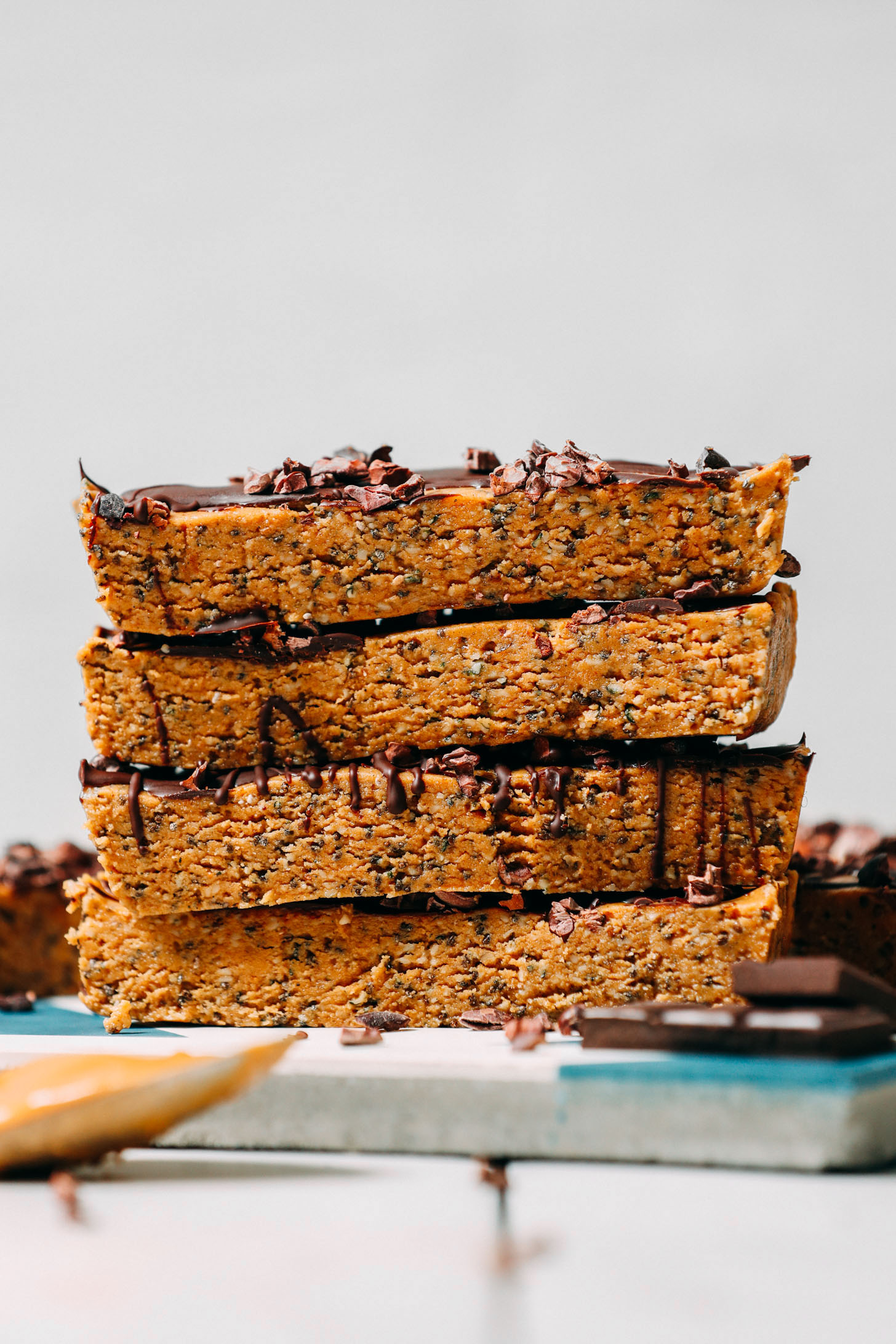 Homemade date-sweetened protein bars piled up in a stack