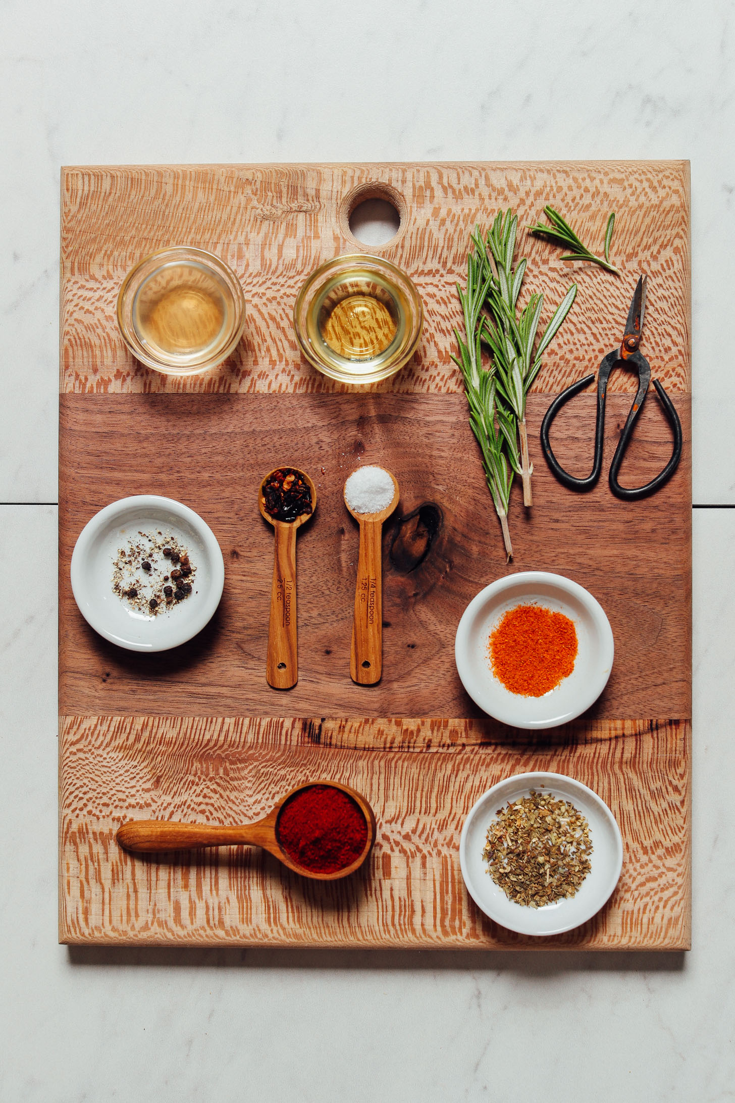 Cutting board with spices showing how to season grilled chicken