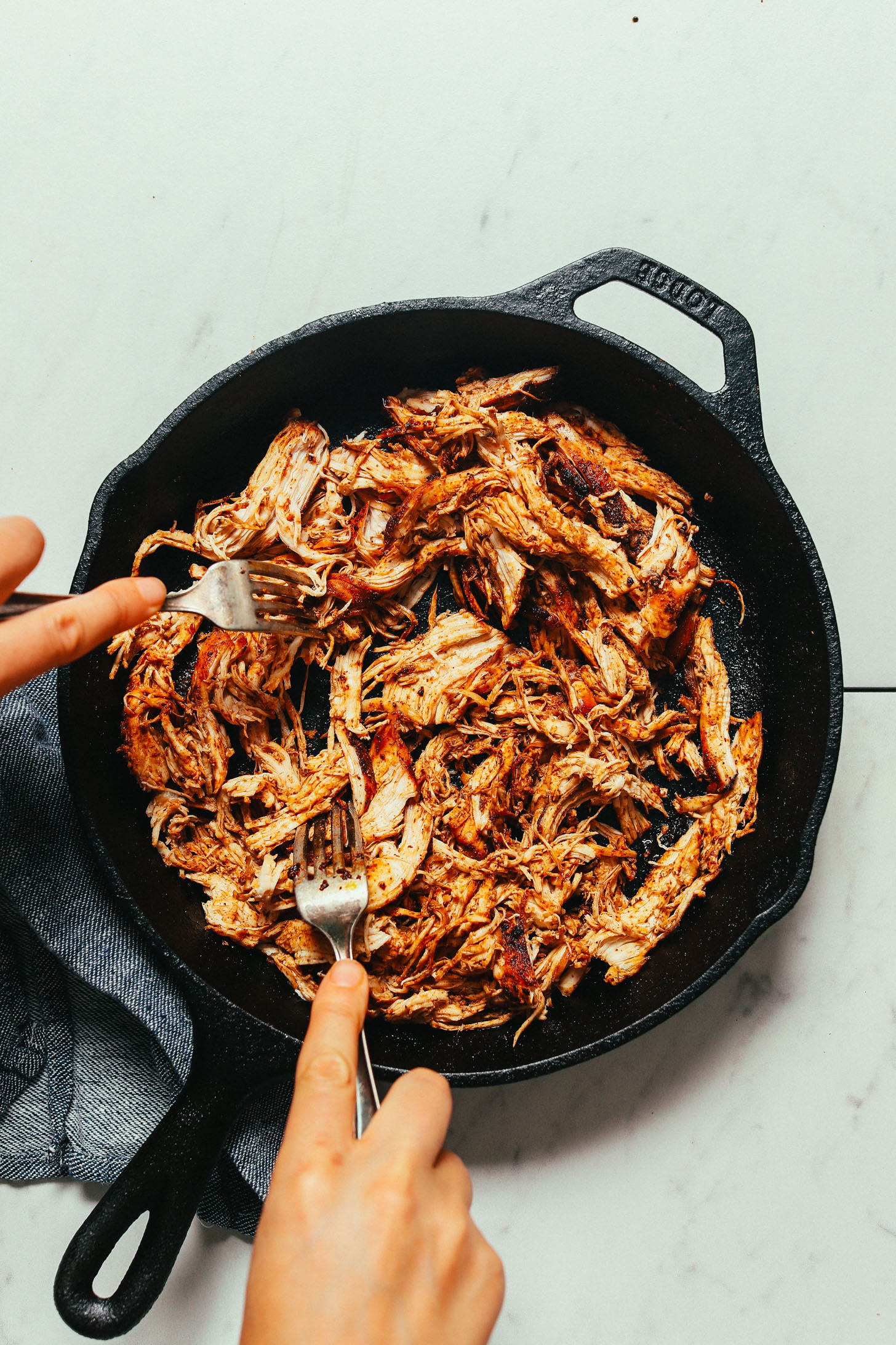 Using two forks to show How to Shred Chicken for our Mexican Chicken recipe