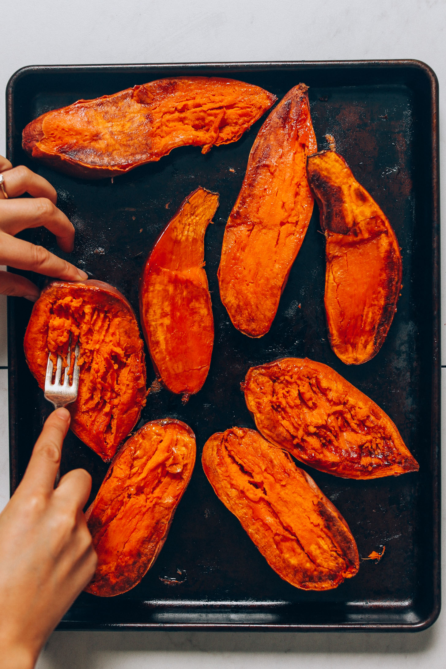Using a fork to mash sweet potatoes for making Sweet Potato Boats