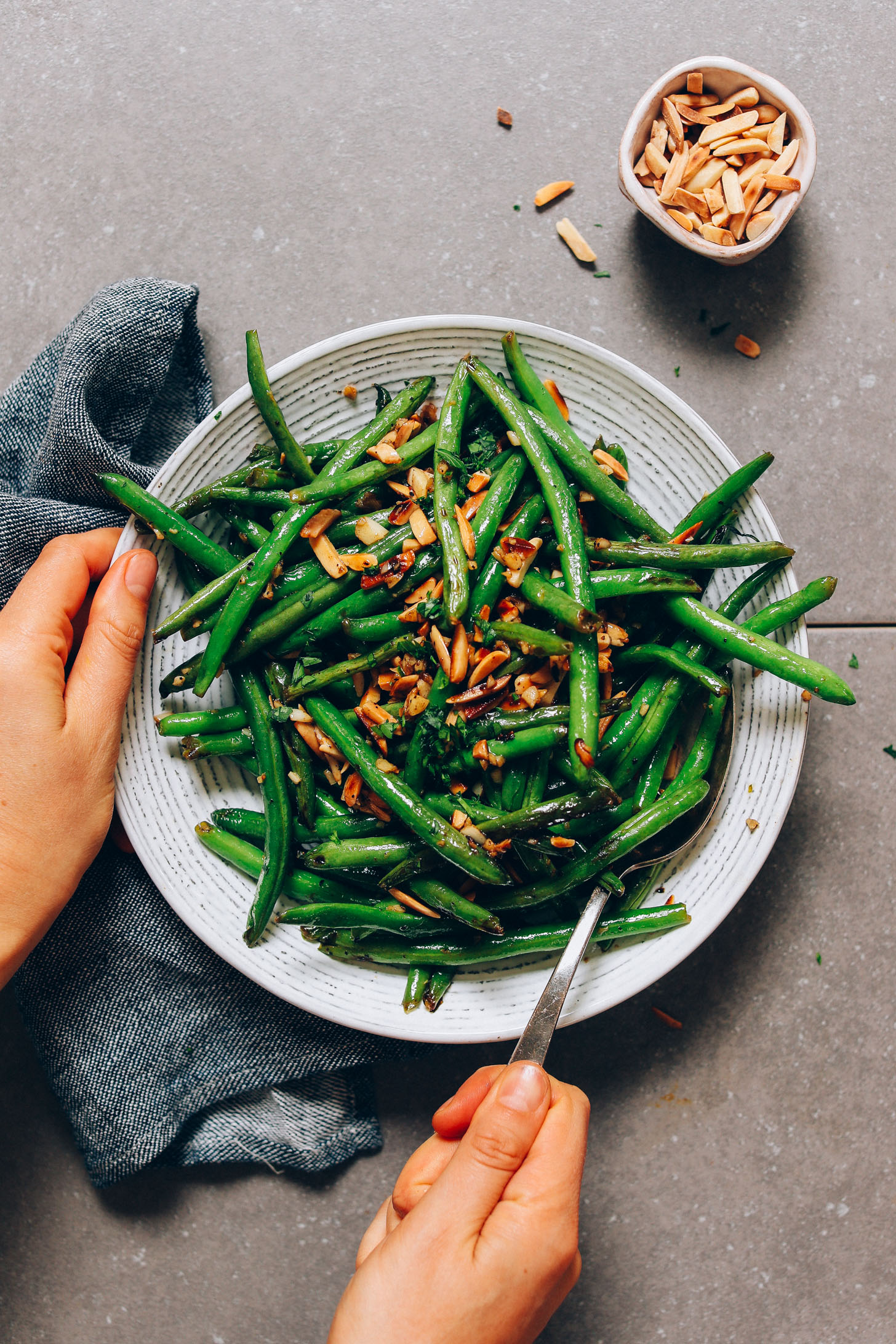 Bowl of our Garlic Green Beans recipe topped with slivered almonds