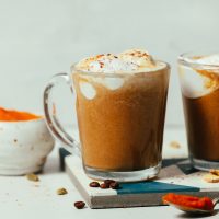 Mug of our dairy-free Pumpkin Spice Latte recipe topped with coconut whipped cream