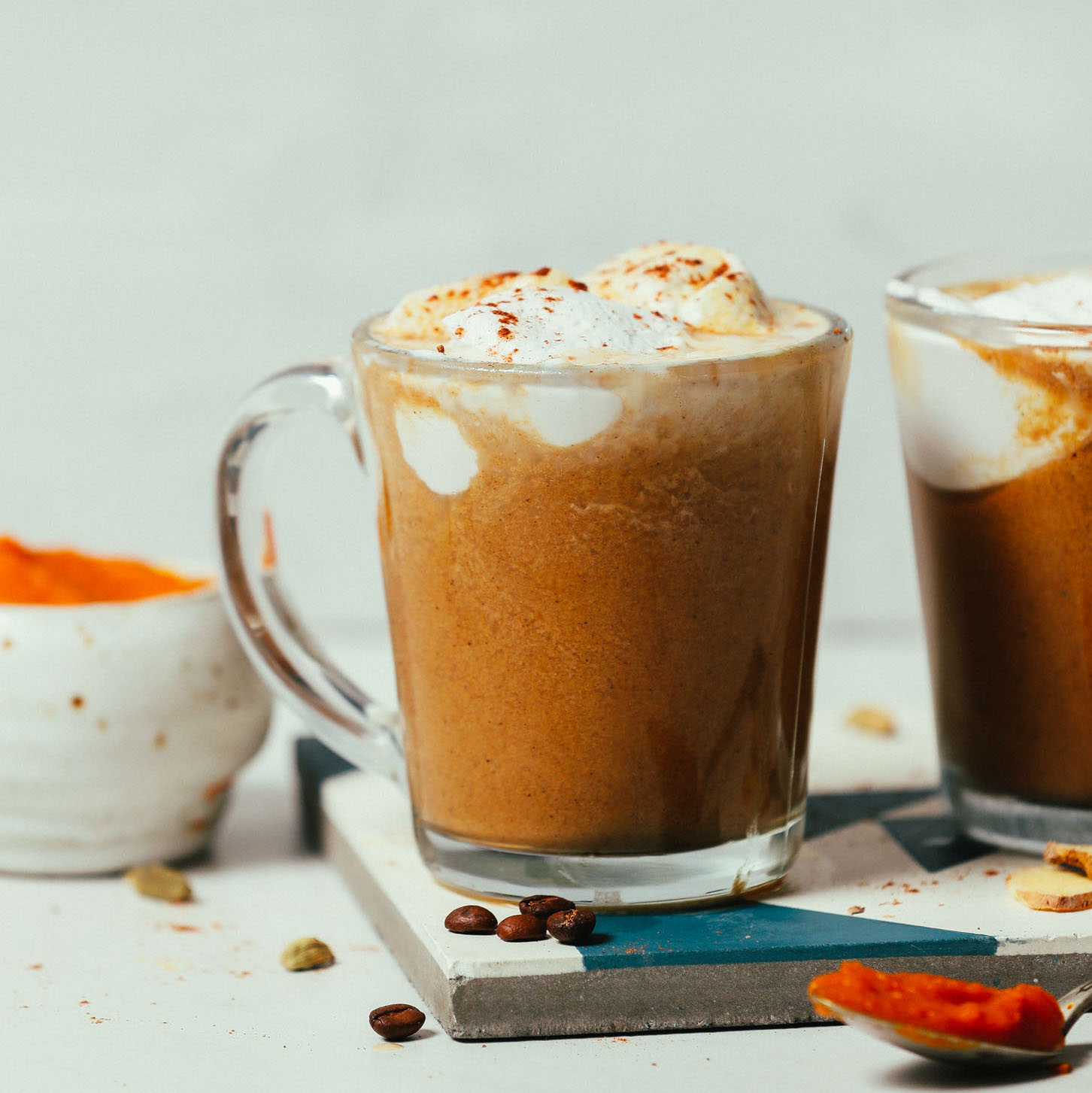 Mug of our dairy-free Pumpkin Spice Latte recipe topped with coconut whipped cream