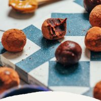 Date-Sweetened Chocolate Truffles on a blue and white tile