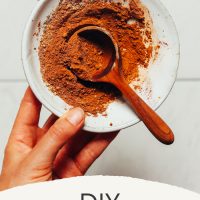 Small wooden spoon in a bowl of DIY Pumpkin Pie Spice