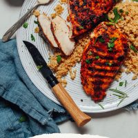 Plate of quinoa topped with our Marinated Grilled Chicken Breast recipe