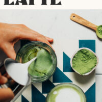 Pouring steamed dairy-free milk into a mug to make our 3-ingredient caffeine-free moringa latte that tastes a little like matcha