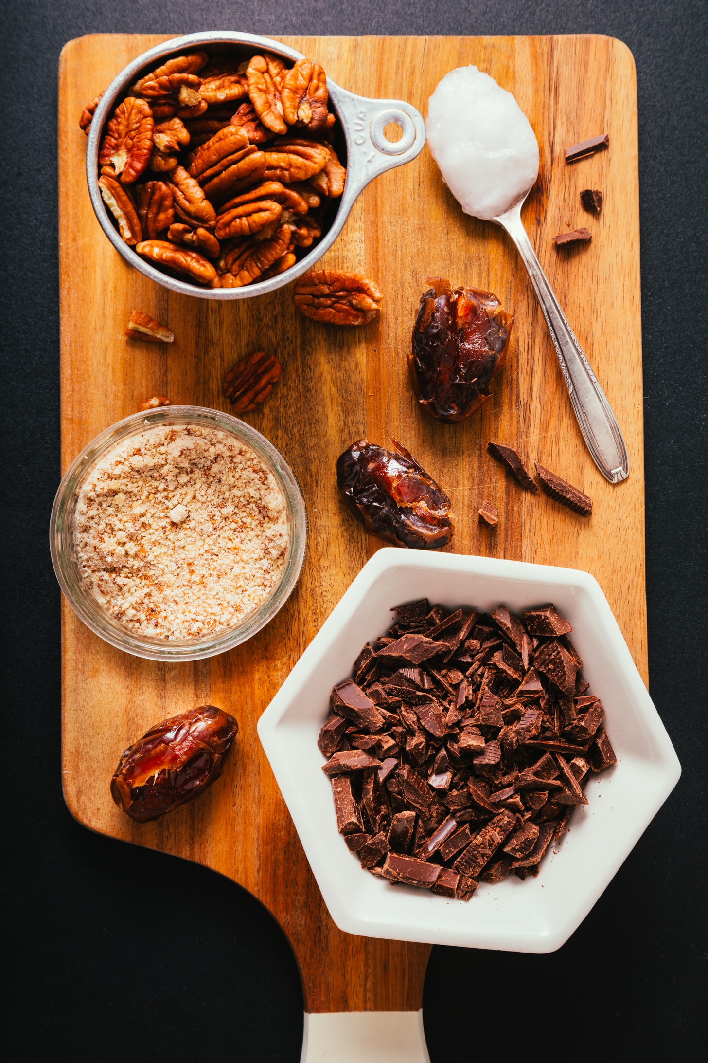 Wood cutting board with ingredients for making our Vegan Chocolate Turtle Candies