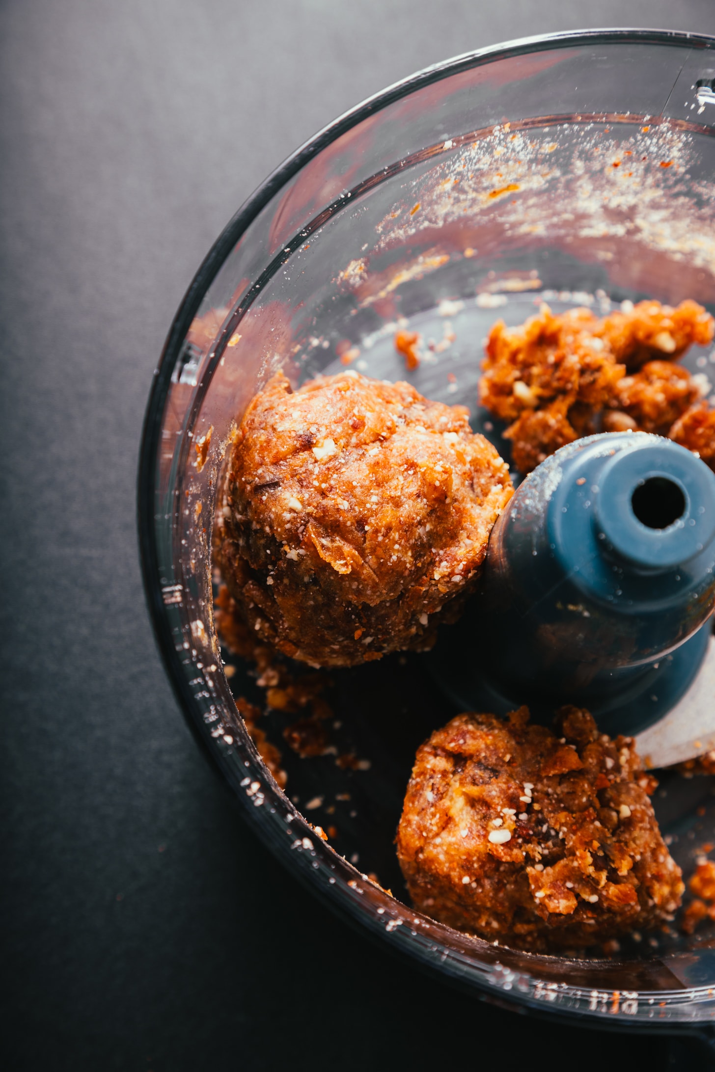Mixing dates and almond meal in a food processor to make homemade Turtle Candies