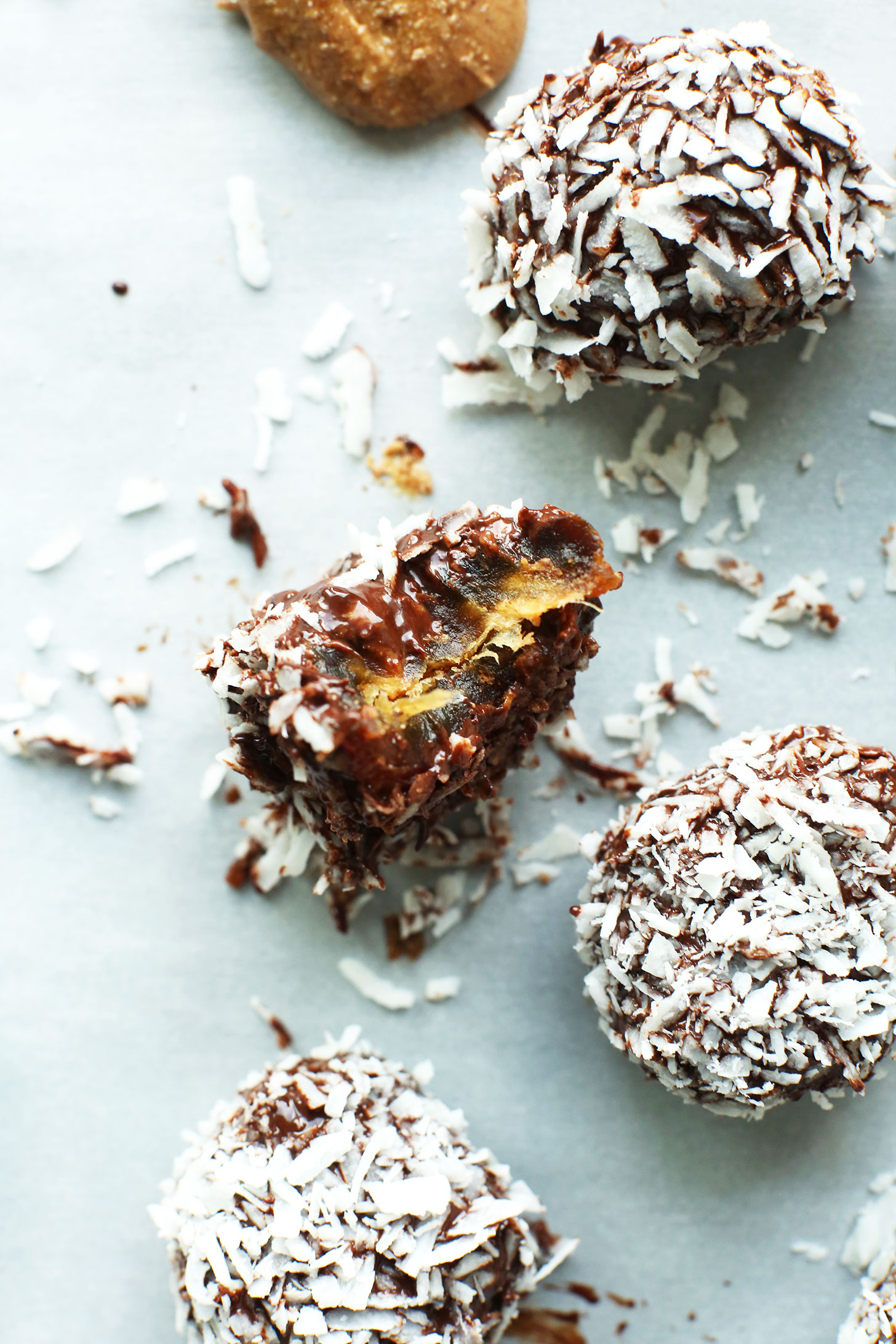 Almond Butter Dark Chocolate Snowballs made with dates and rolled in shredded coconut