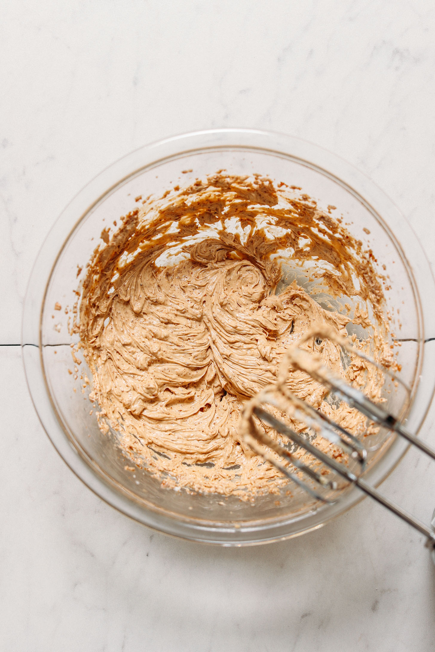 Using egg beaters to whip the batter for our Vegan GF Snickerdoodle Cookies recipe