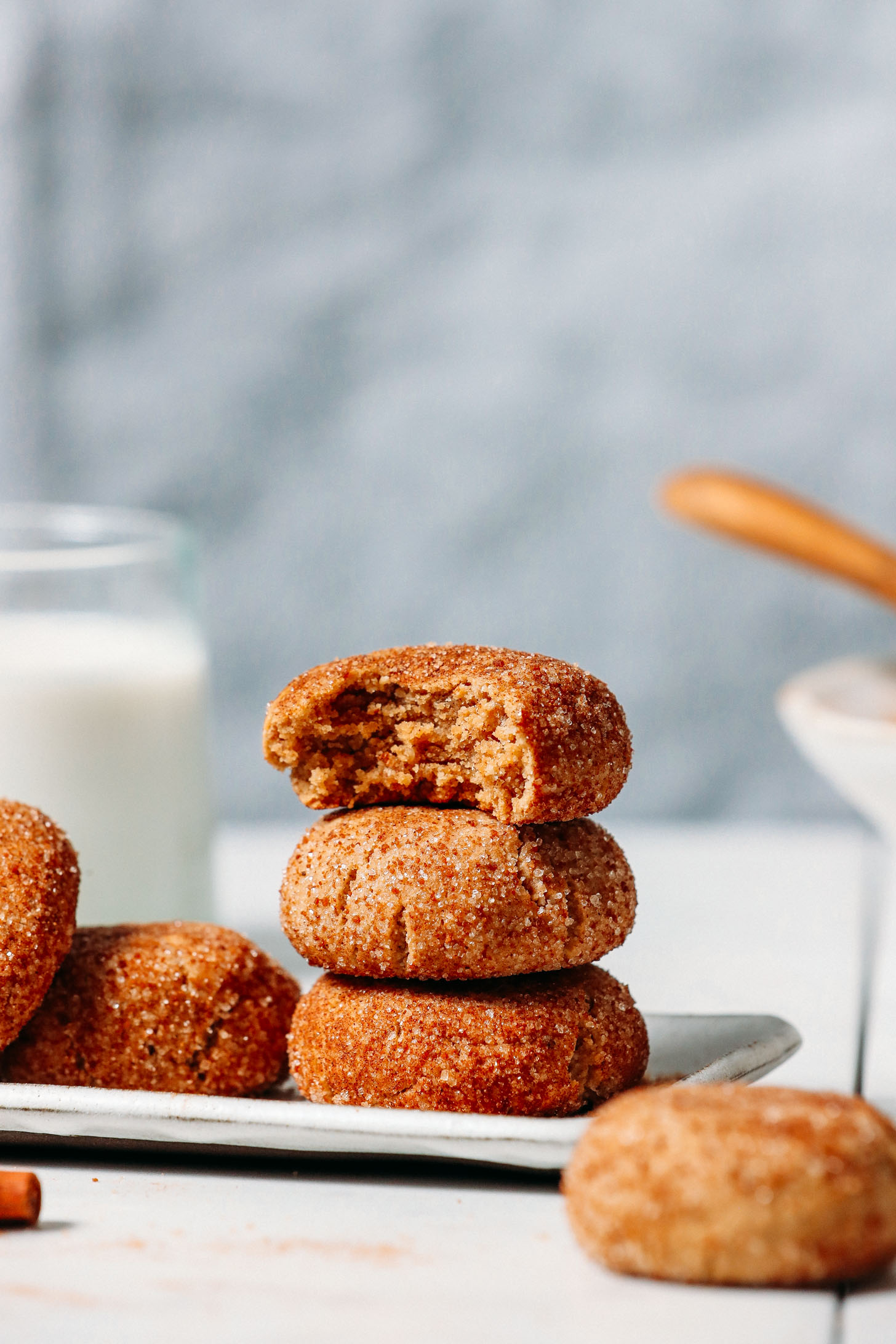 Stack of Gluten-Free Vegan Snickerdoodle Cookies with the top cookie missing a bite