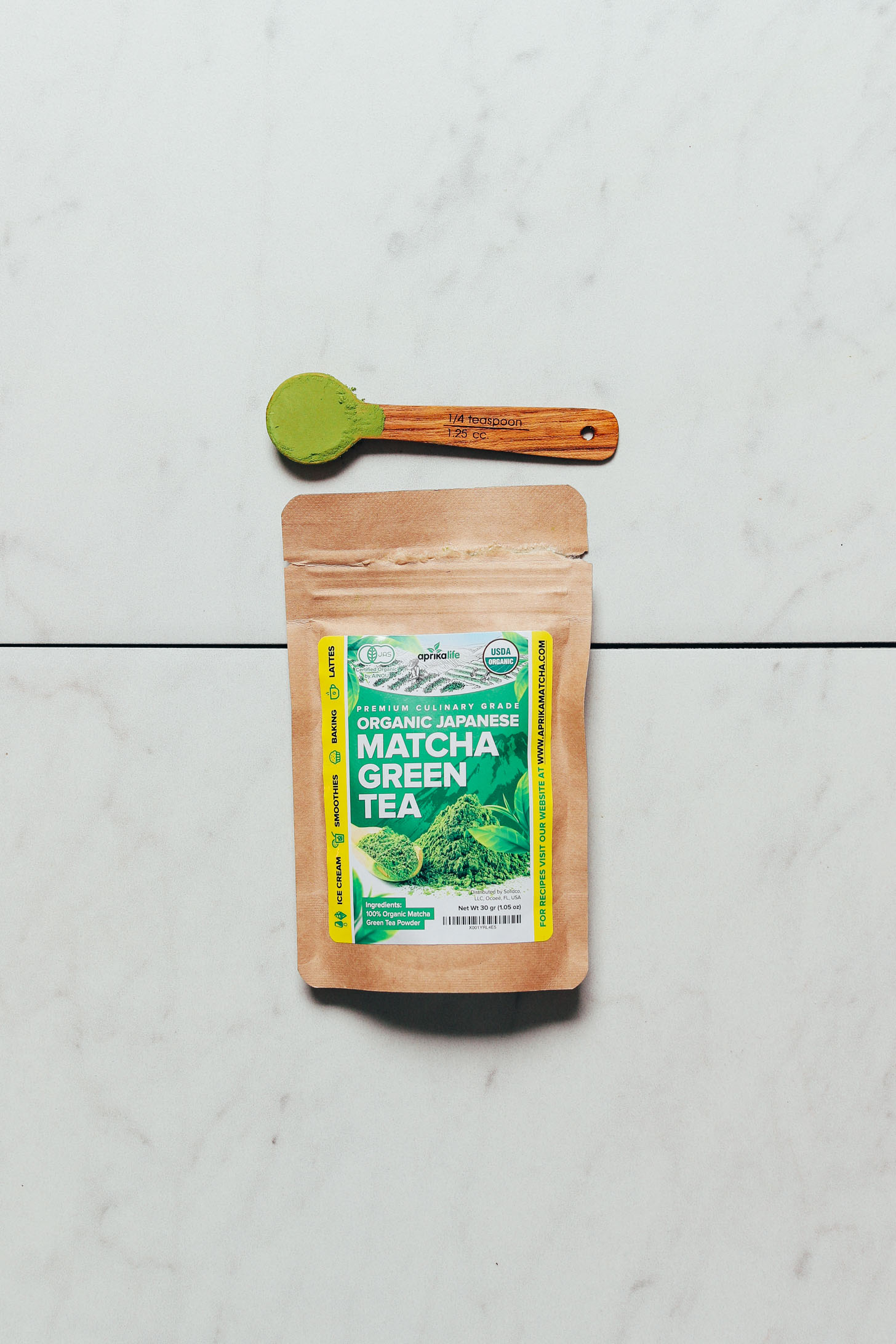Spoonful and package of Aprika Life Matcha for our top favorite brand of culinary matcha