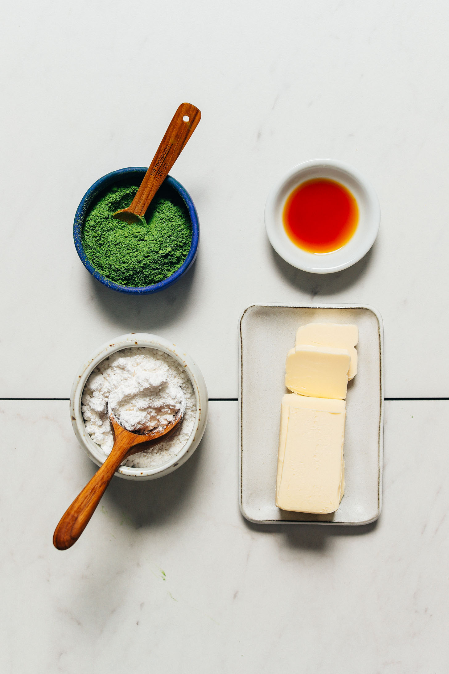 Vegan butter, matcha, powdered sugar, and vanilla for making our Vegan Matcha Frosting recipe