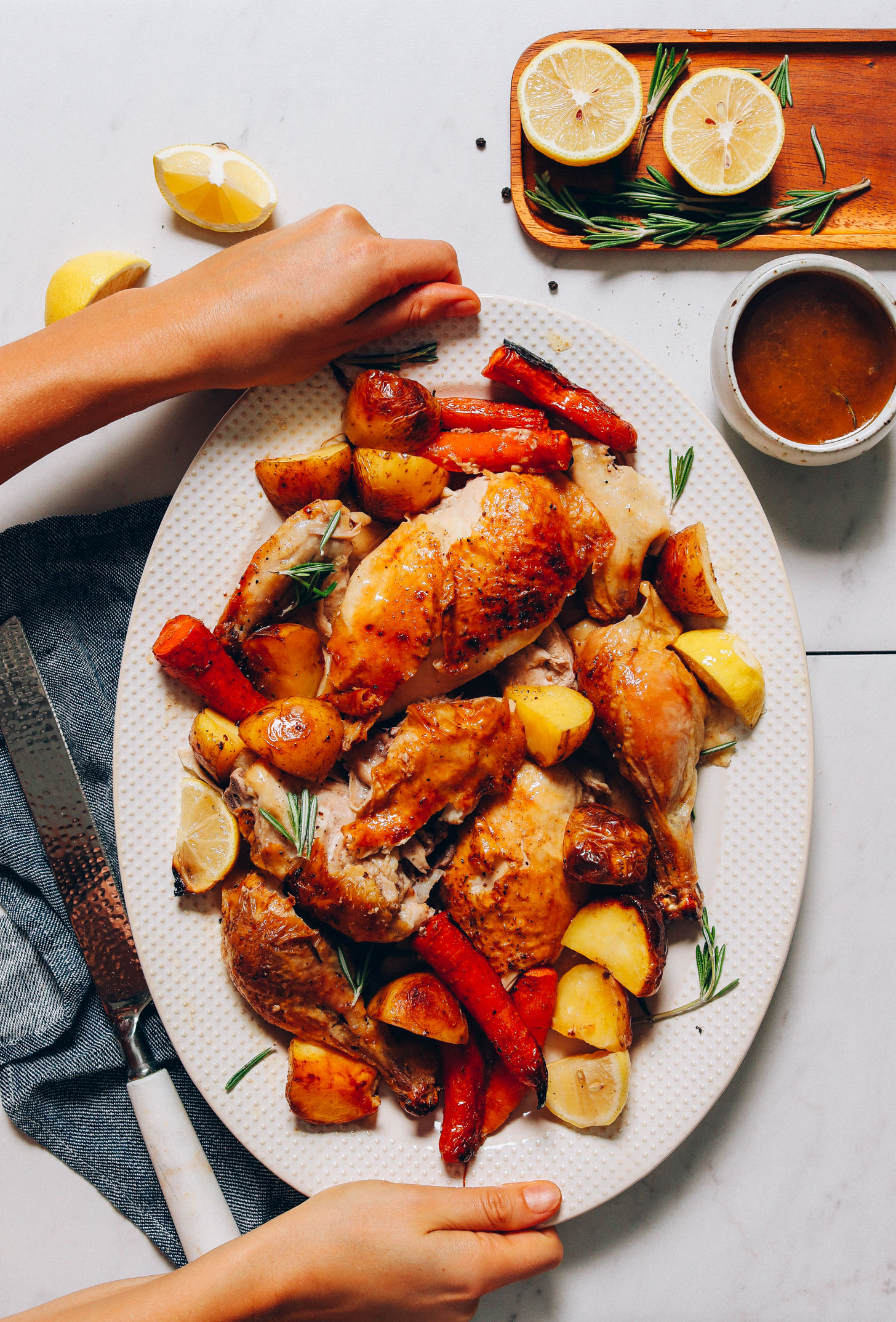 Platter of Roasted Chicken and Vegetables with fresh rosemary and lemons