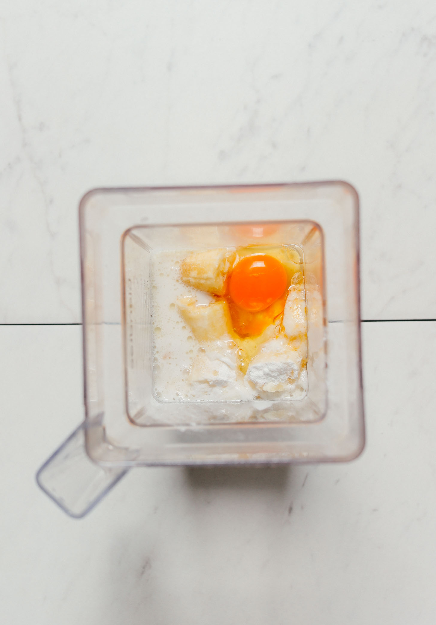 Egg in a blender with other ingredients for making our Banana Pancakes recipe