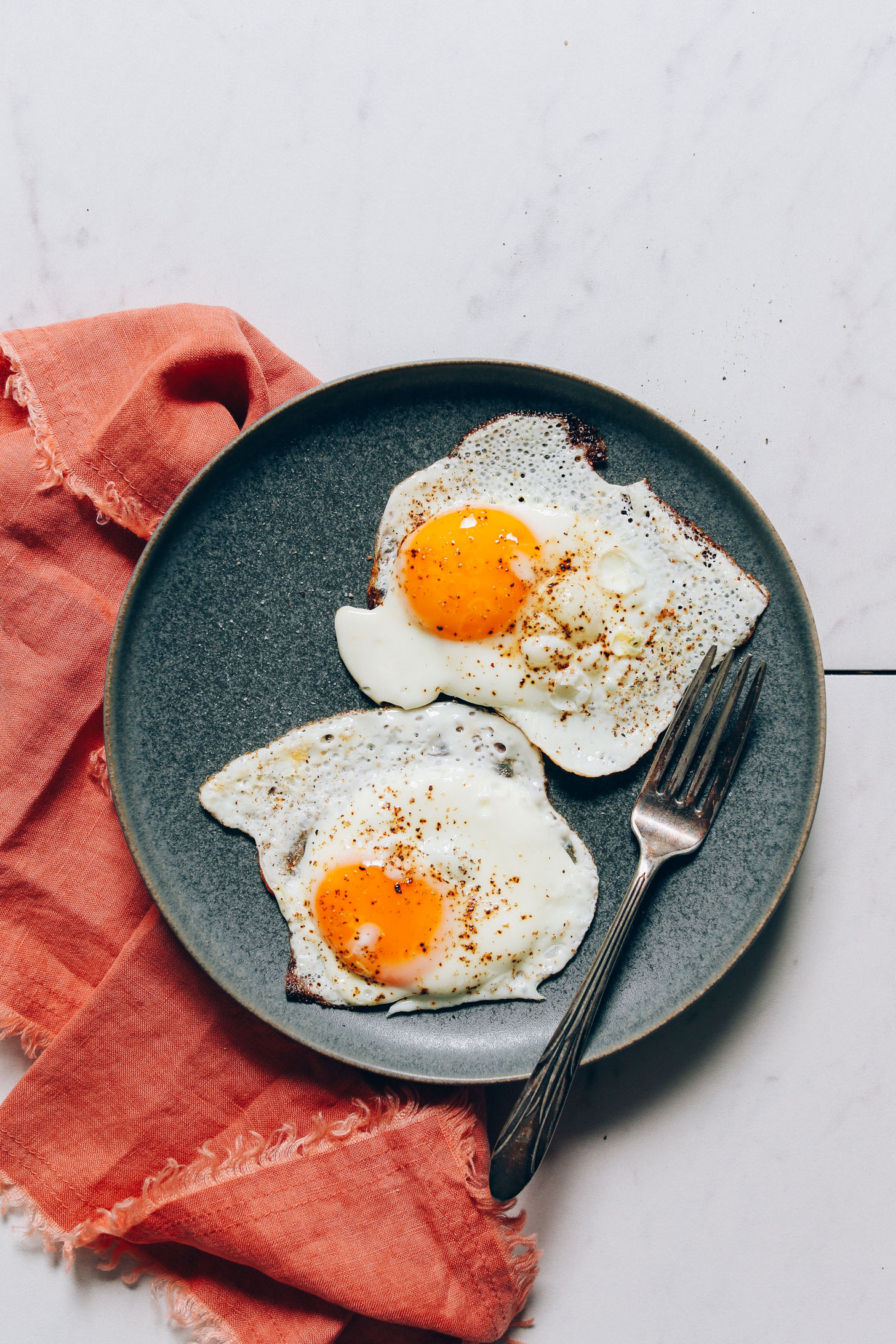 Plate of two perfectly cooked runny yolk eggs for our tutorial on How to Cook an Egg