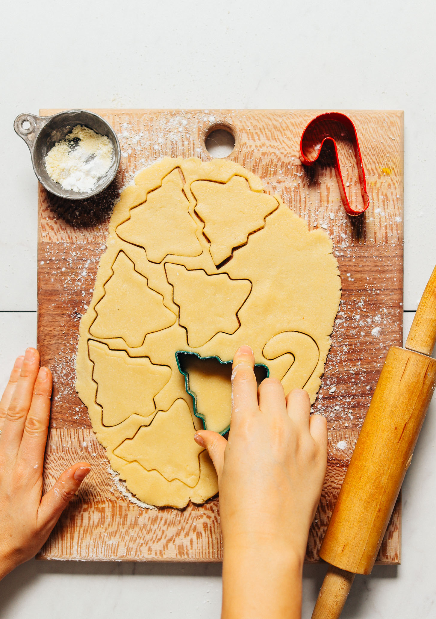 Using a Christmas tree cookie cutter to make Grain-Free Sugar Cookies