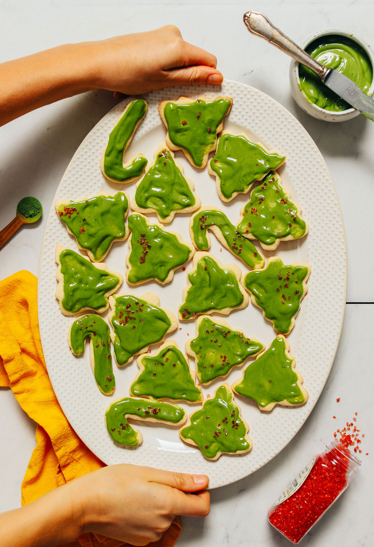 Platter of Grain-Free Christmas Cookies with matcha frosting and red sprinkles