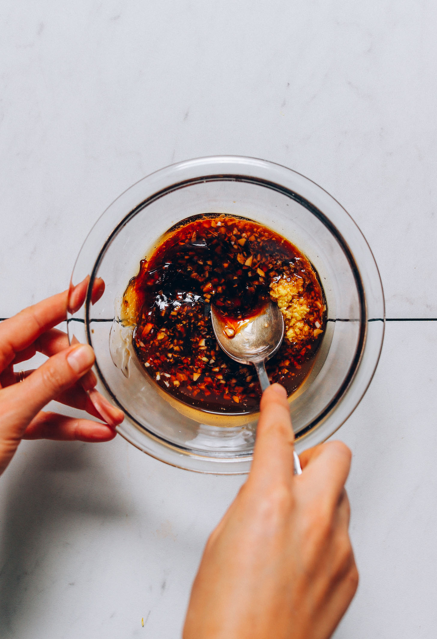 Stirring together Sesame Ginger Dressing made with coconut aminos