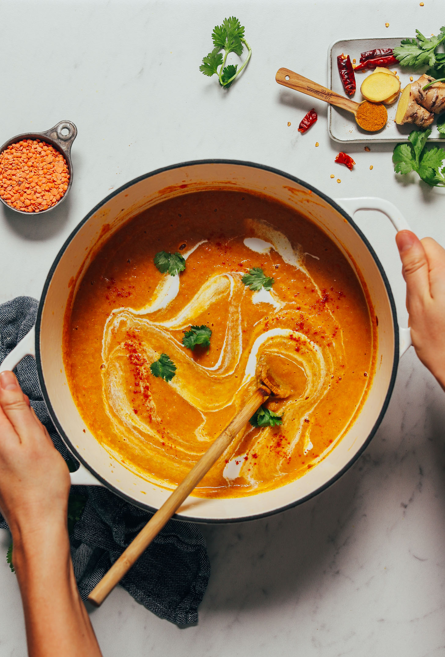 Holding a pot of Curried Cauliflower Lentil Soup