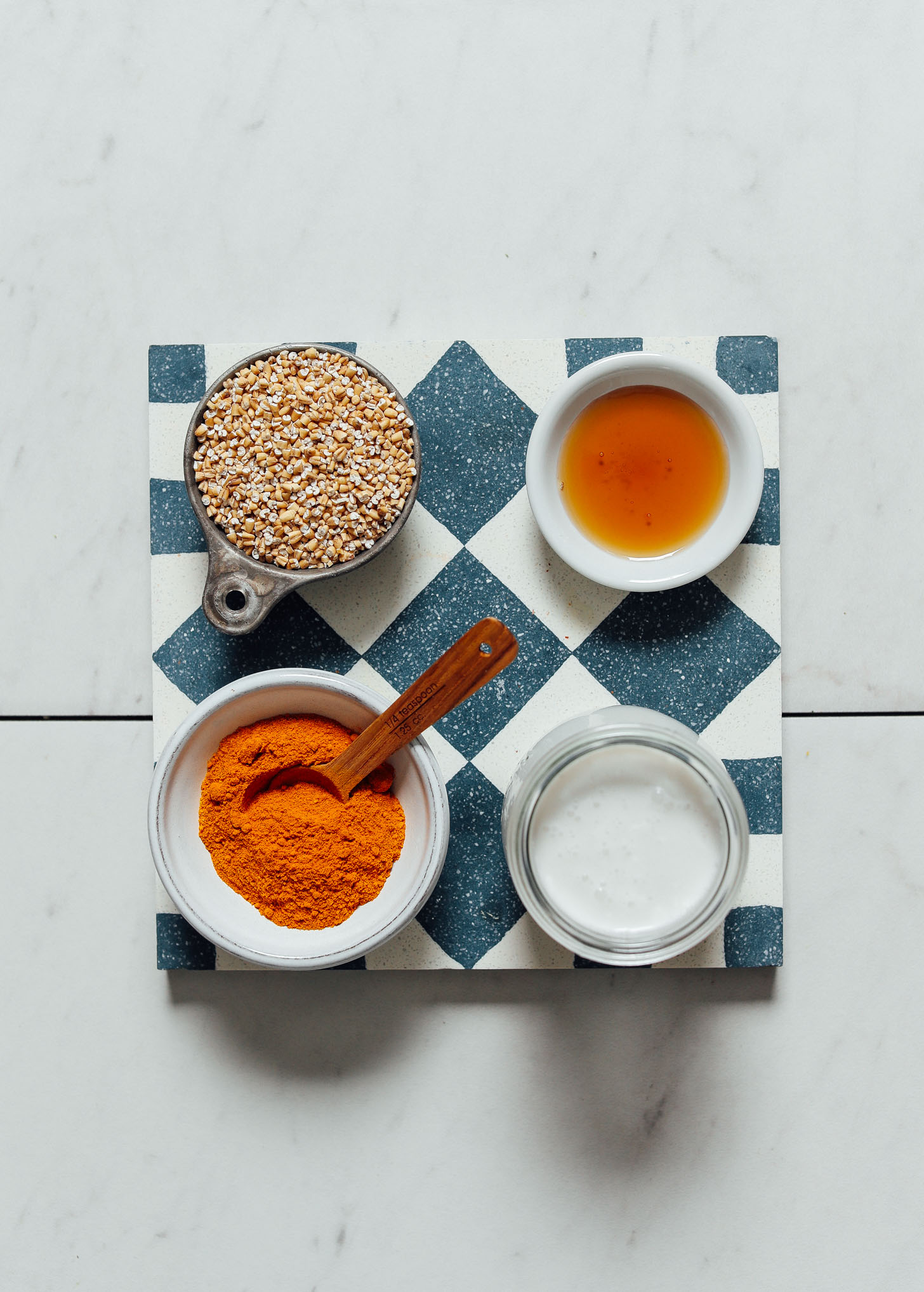 Steel cut oats, turmeric, coconut milk and maple syrup for making our Cozy Turmeric Porridge recipe
