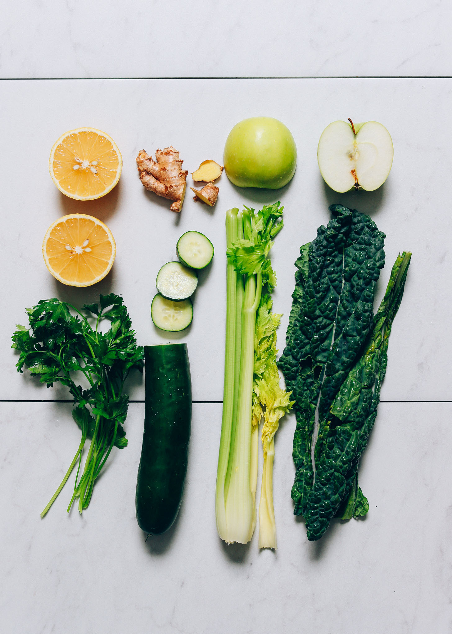 Cucumber, parsley, lemon, ginger, apple, kale, and celery for making homemade Green Juice